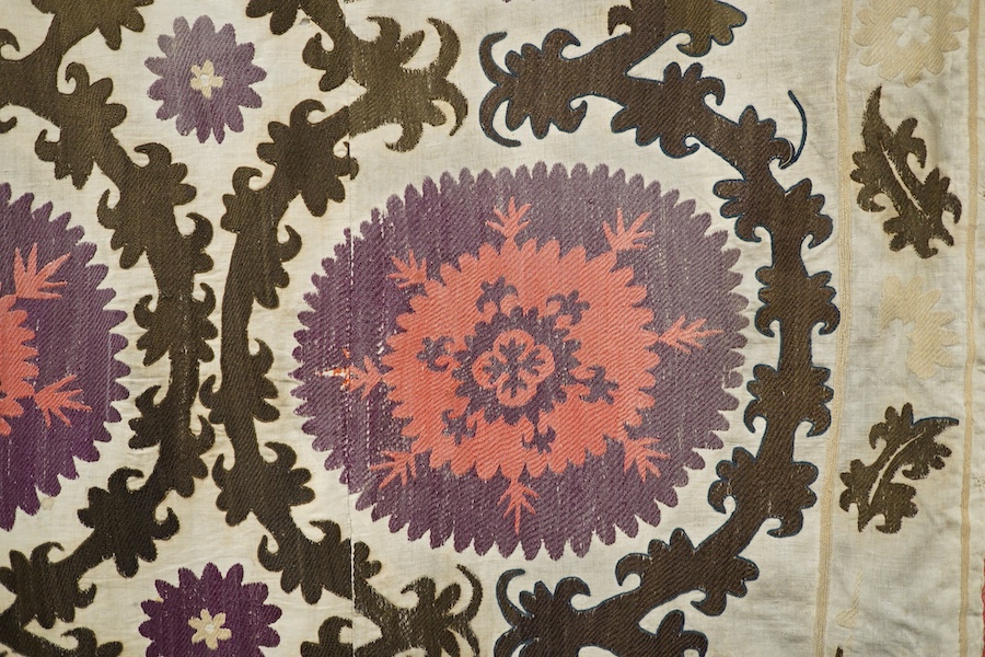 A late 19th early 20th century Uzbekistan (possibly Samarkand) embroidered Suzani. Made from hand loomed linen, pieced together then hand embroidered with large decorative sun or moon motifs as a large table cover or han